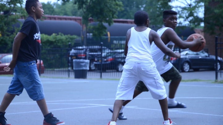 Boys play basketball on the Ezra Prentice Homes playground in Albany, N.Y. The public housing project borders the Kenwood rail yards, a hub for trains carrying crude oil.