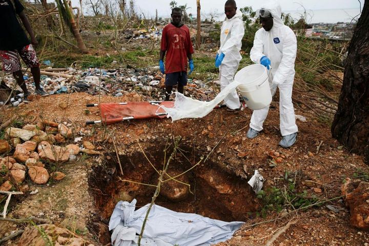 Workers bury two bodies after Hurricane Matthew passes Jeremie, Haiti.