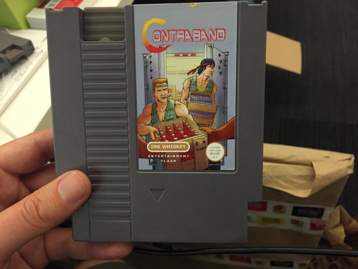 A Nintendo cartridge flask parodying the classic game "Contra."