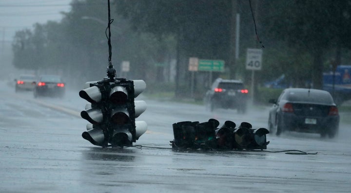 A traffic light hangs in an intersection as Hurricane Matthew moves through Jacksonville, Fla.