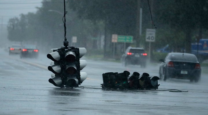 A traffic light hangs in an intersection as Hurricane Matthew moves through Jacksonville, Fla.