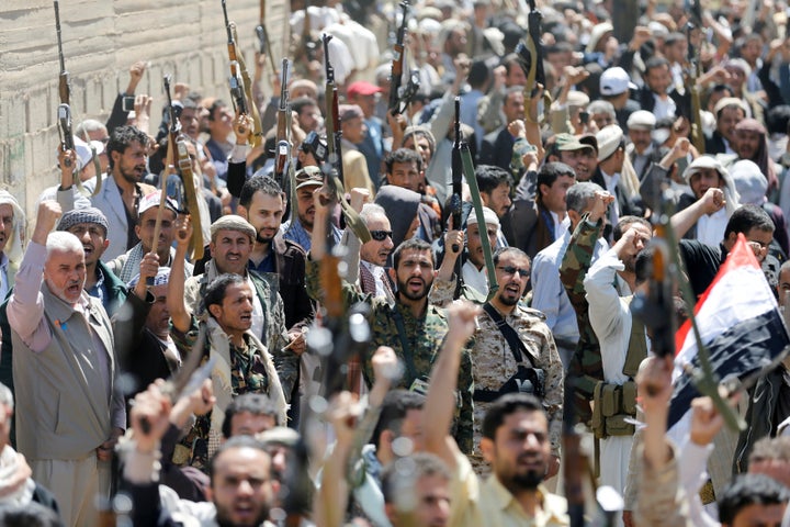 Armed people demonstrate outside the United Nations offices against Saudi-led air strikes on funeral hall in Sanaa, the capital of Yemen, October 9, 2016