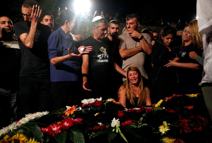 Relatives and friends mourn over the grave of Israeli policeman in Jerusalem October 9, 2016.