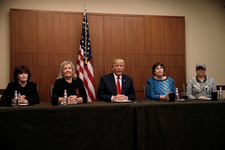 Donald Trump sits with (from R-L) Paula Jones, Kathy Shelton, Juanita Broaddrick and Kathleen Willey in a hotel conference ro