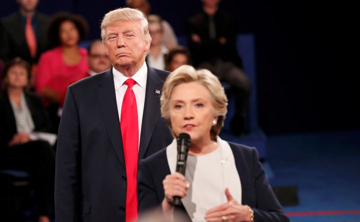 Trump listens as Clinton answers a question from the audience during their presidential town hall debate