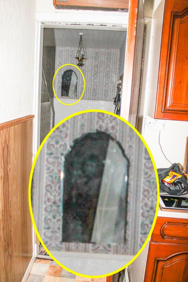 This picture, taken in June, purportedly shows an eerie face in a hooded black robe, staring out of a mirror at the bottom of the stairs 