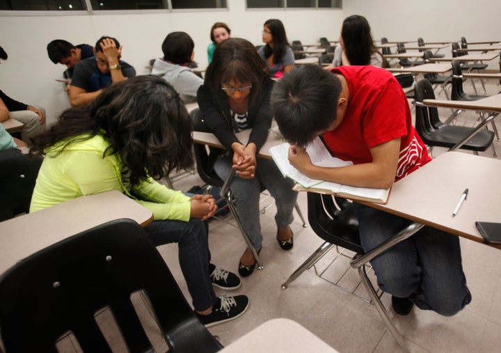 Students pray during Intervarsity Christian Fellowship meeting at Cal State Northridge on SEPTEMBER 22, 2014.