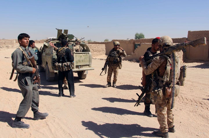 Afghan Special Forces and policemen prepare themselves for battle with the Taliban on the outskirts of Lashkar Gah capital of Helmand, Afghanistan October 10, 2016.