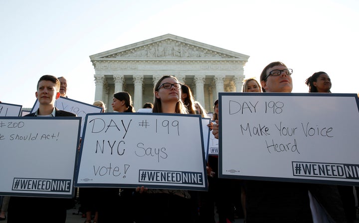 Activists gather outside the Supreme Court to protest the more than 200 days that Judge Merrick Garland, President Barack Obama's nominee to the Supreme Court, has waited for a hearing.