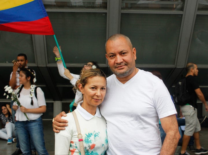 Nicolás Guillermo Hernon (right), mayor of the small town of Anorí, Antioquia enjoys the pro-peace festivities before the march with his secretary.