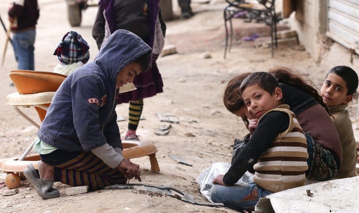 Syrian refugees play in the streets of Damascus on February 18, 2015.