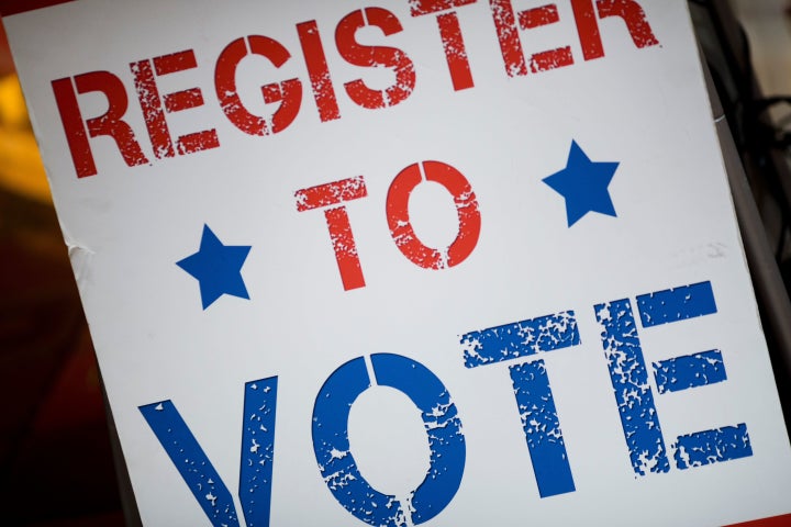 A voter registration sign is seen before a viewing event for the first presidential debate between Donald Trump and Hillary Clinton in Cambridge, Massachusetts.