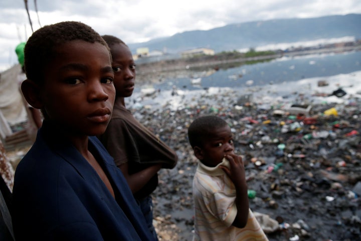 Children stand next to a flooded area after Hurricane Matthew passes Cite-Soleil in Port-au-Prince, Haiti, October 5, 2016.