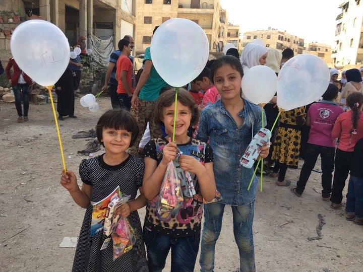 Syrian schoolchildren in Aleppo pose with their white balloons.