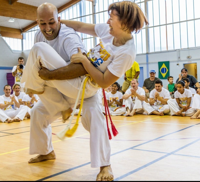 It is a part of the ritual at Batizados for mestres to take down beginners in a gentle fashion. Take downs between profession