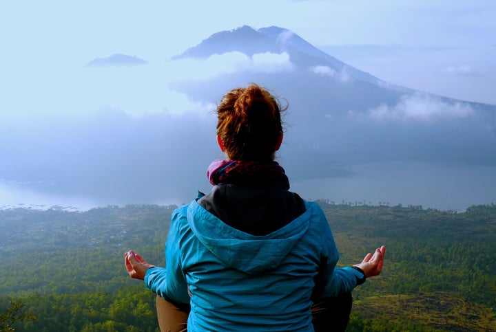 Taking in a moment of reflection after hiking an active volcano to see the sunrise in Bali, Indonesia