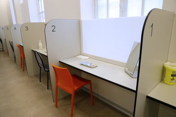 A room with cubicles with trays of injection materials is seen at the SCMR (Drug supervised injection site).