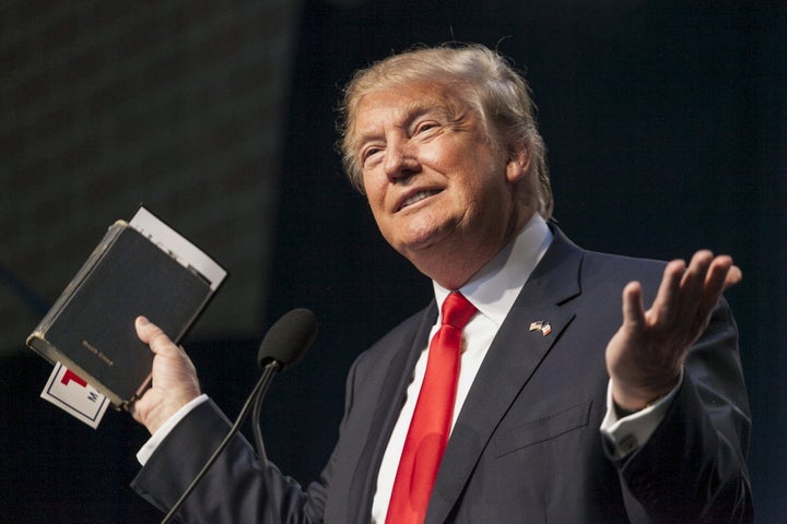 U.S. Republican presidential candidate Donald Trump holds his bible while speaking at the Iowa Faith and Freedom Coalition Forum in Des Moines, Iowa, September 19, 2015.