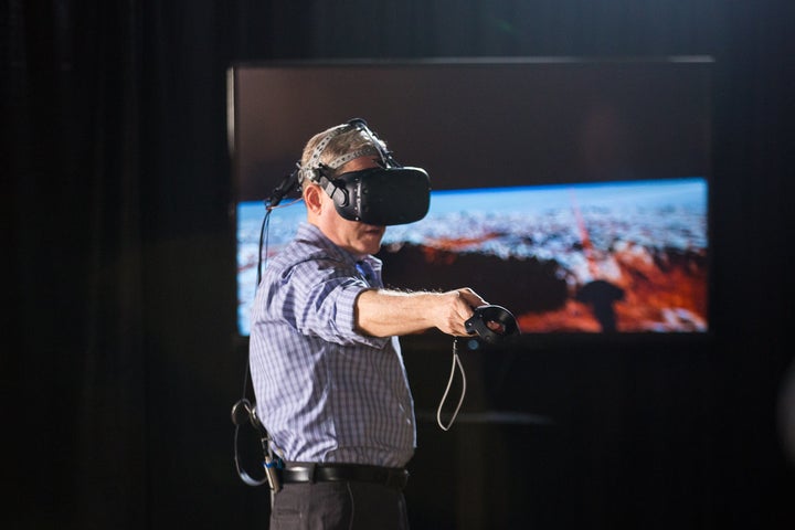 Alan Stern, a NASA scientist who led the mission for the exploration of Pluto, checks out the Pluto VR experience.