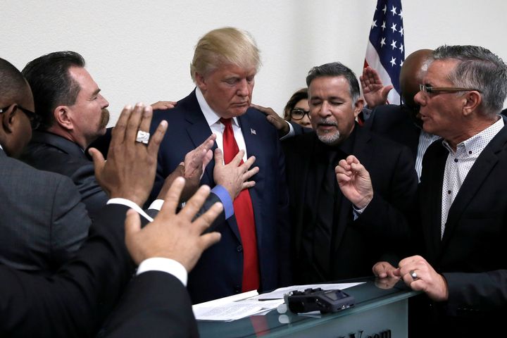 Republican presidential nominee Donald Trump prays with pastors during a campaign visit to the International Church of Las Vegas and the International Christian Academy in Las Vegas, Nevada, U.S., October 5, 2016.