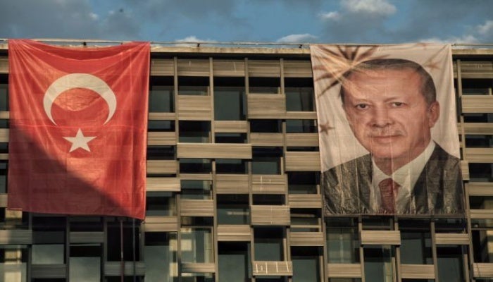 President Recep Tayyip Erdogan's poster hangs over a cultural center in Istanbul's Taksim Square.
