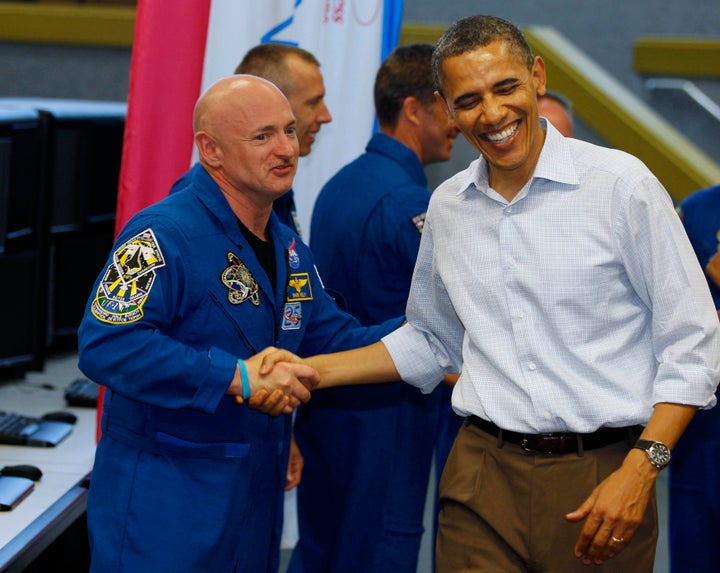 U.S. President Barack Obama shakes hands with space shuttle Endeavour mission commander Mark Kelly (R) after the mission was postponed at the Kennedy Space Center at Cape Canaveral, Florida, April 29, 2011.