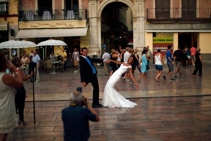 A newly married couple poses at La Constitucion square in Malaga, Spain, on July 11, 2014.