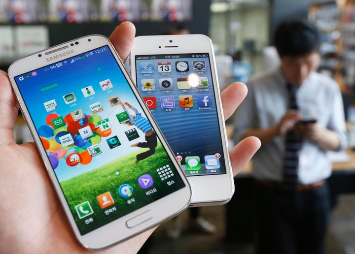 Samsung Electronics' Galaxy S4, left, with Apple's iPhone 5.