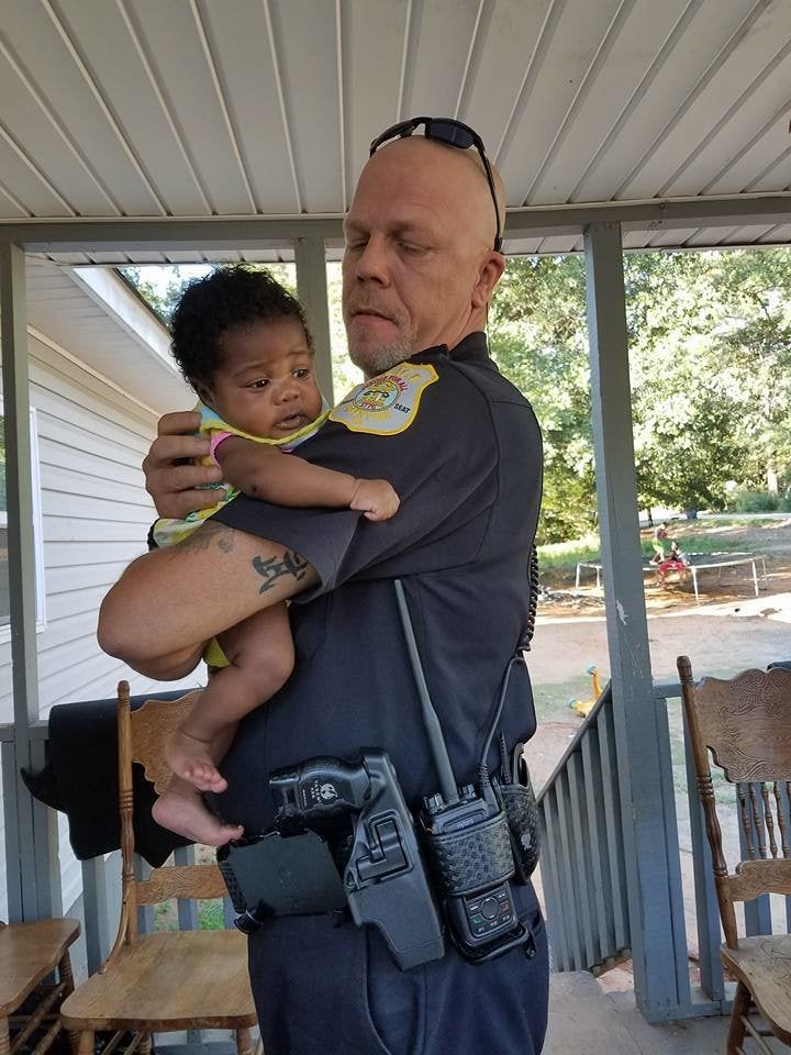 Two-month-old Ma'Yavi Parham with her godfather, Officer Kenneth Knox.