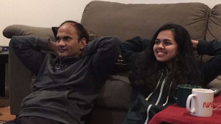 Riya and her dad relaxing together at home.