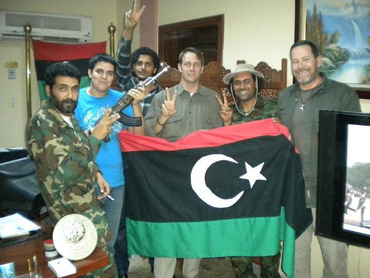 Brad Owens (center), then with Torres Advanced Enterprise Solutions, stands with some of the local people he worked with in Libya. The photo was taken after the fall of Tripoli, before Muammar Gaddafi was killed. The gun belonged to one of Gaddafi's sons, Owens said.