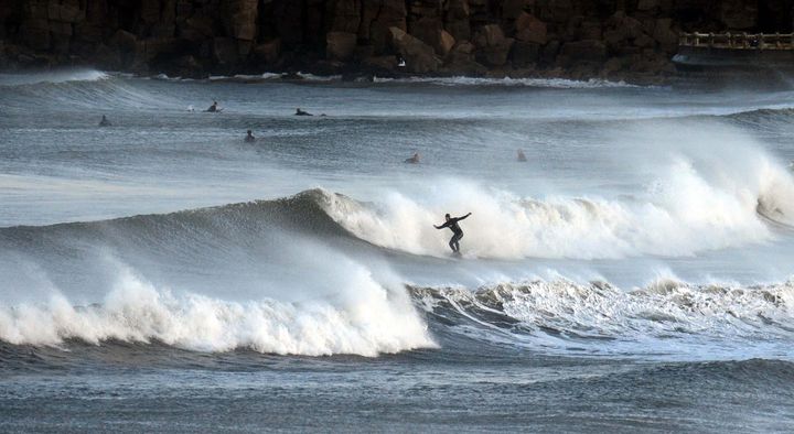 Surfers at Tynemouth enjoying the 'Indian summer' attributed to climate change