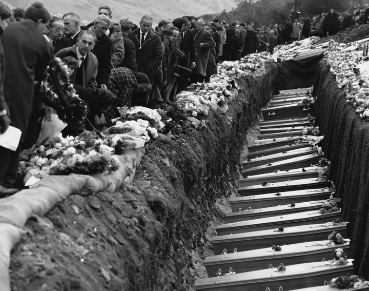 Mourners at the graves of the 144 victims of the disaster