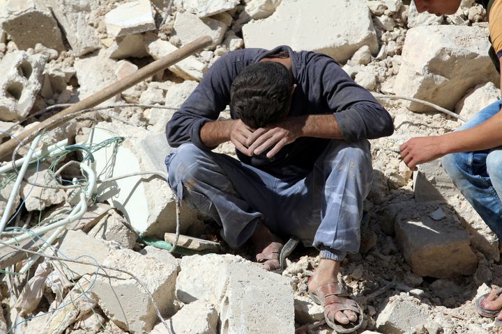 A man in Aleppo weeps after losing relatives in an airstrike on Oct. 11, 2016.