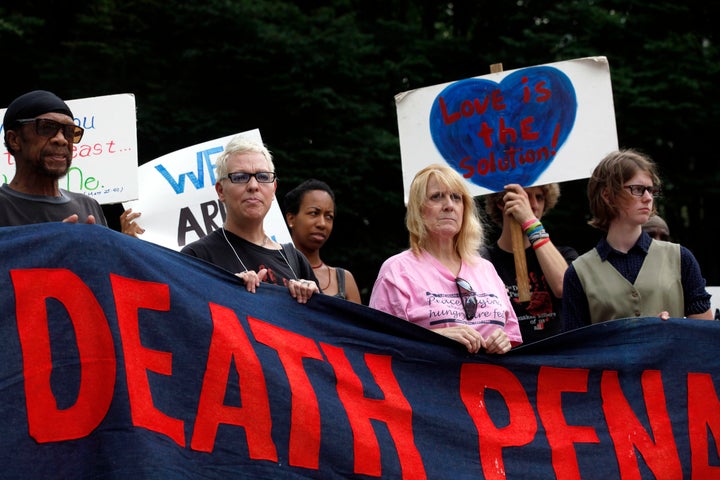 Demonstrators celebrate the saved life of Warren Hill, a mentally disabled man condemned for a 1990 killing of a fellow inmate, while also protesting the death penalty in Georgia at Woodruff Park, on July 15, 2013.