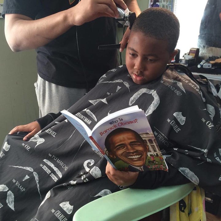 A boy reading about President Obama.