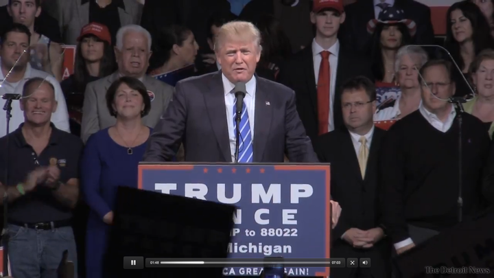 Pannebecker (at bottom left) claps at a Trump rally in Novi, Michigan, in September.