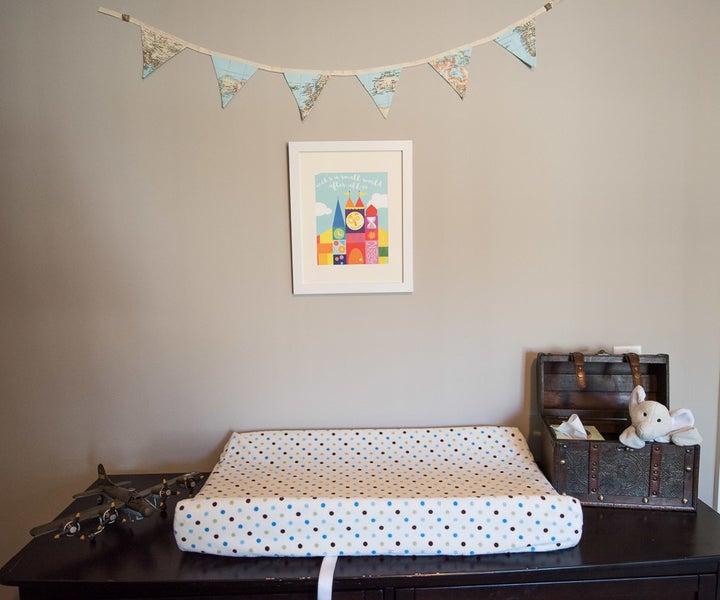 We livened up the changing table with our Snuggin peaking out from a box and map bunting from LinenandLaceHandmade on Etsy.