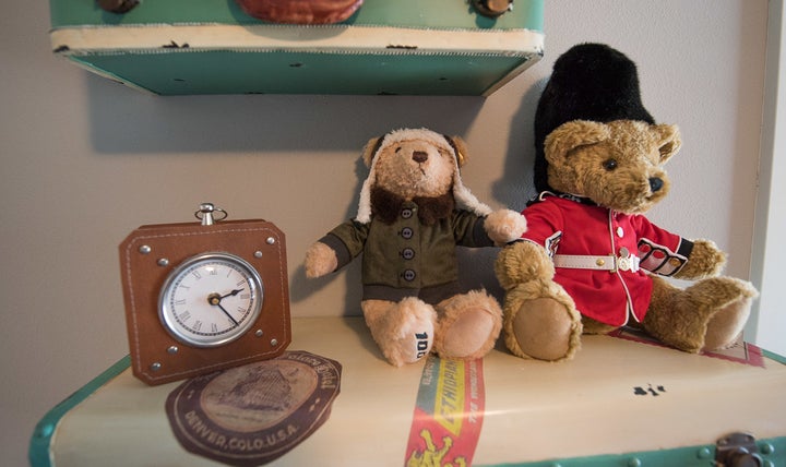 These vintage-reproduction shelves from PB Teen are a focal point of the nursery and provide a fun space for decorations like this Boeing 100th Anniversary Teddy Bear from Steiff USA and this Guardsman Teddy from British Teddies.