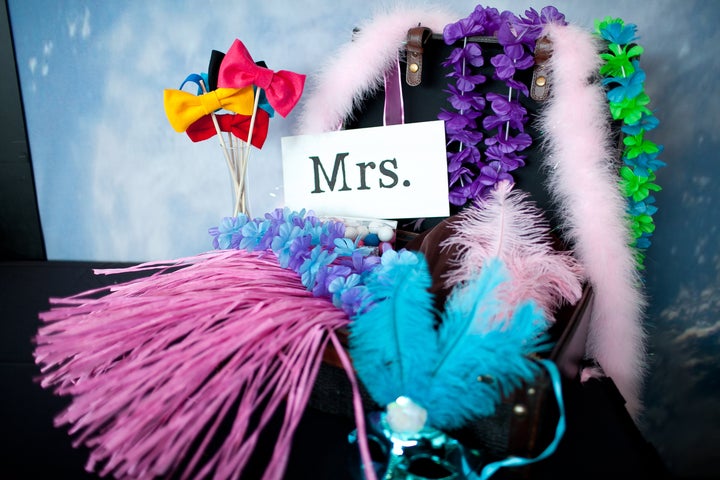 Our photo booth props included Hawaiian leis, hula skirts, cowboy hats, boas, bow ties and more and were displayed in a vintage reproduction suitcase I found at Marshall's.