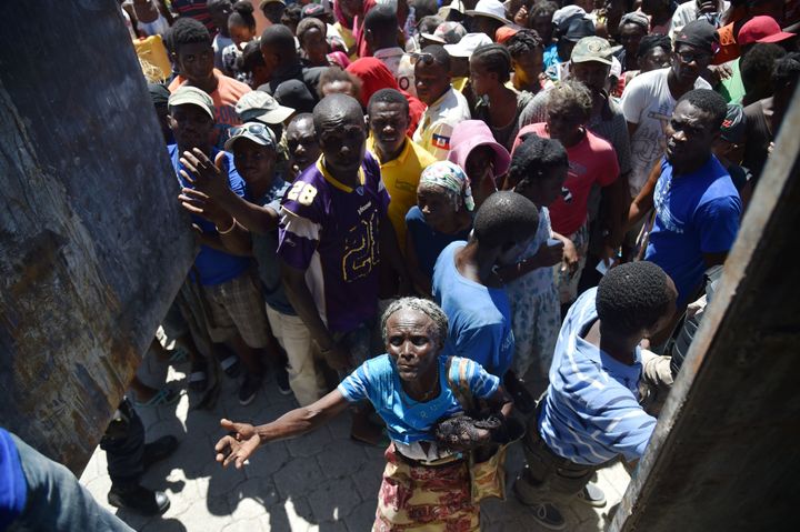 Hurricane Matthew victims receive food from the UN's World Food Programme in Roche-a-Bateaux, in Les Cayes, in the south west of Haiti, on October 12, 2016.