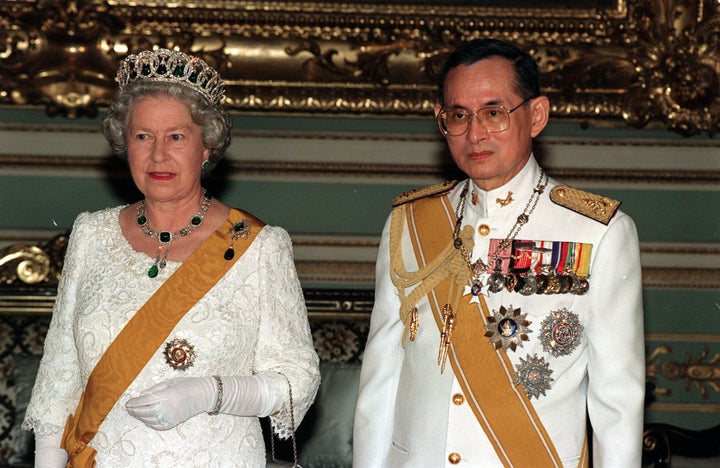 File photo dated 28/10/96 of Queen Elizabeth II and King Bhumibol Adulyadej of Thailand at a state banquet at the Chakri Palace in Bangkok.