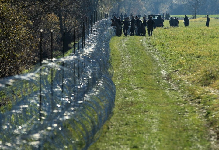 Slovenian soldiers work on a wire fence in the village of Veliki Obrez on Nov. 11, 2015.