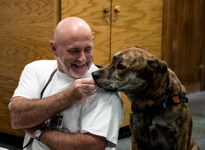 Inmate Keith Birch with a pup named Luto.