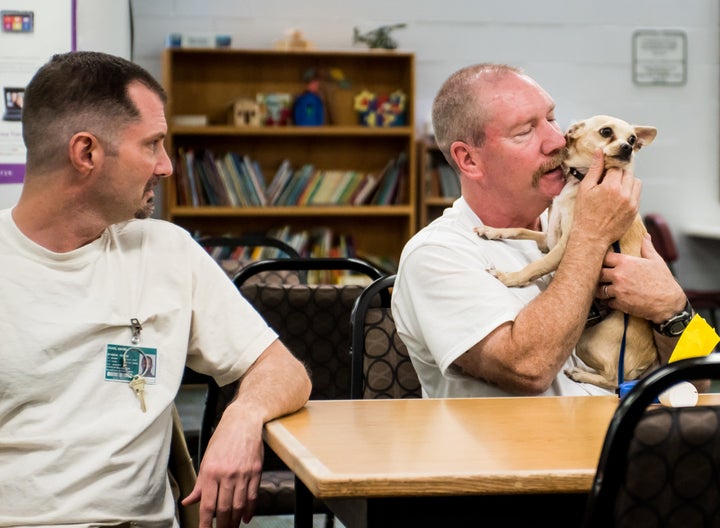 Inmates David Craig (L) and Douglas Gallagher reunite with Skeeter.