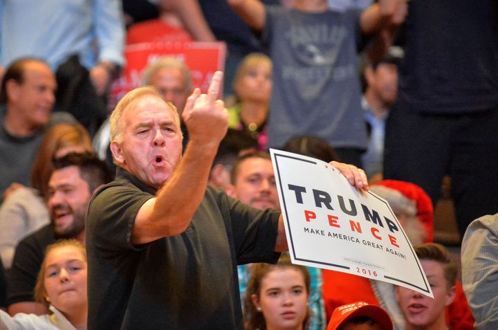 A Trump supporter gives the finger to the media at a rally in Cincinnati on Thursday.