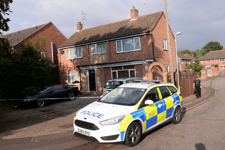 Police stand outside a house in Colchester, Essex, where a baby boy died after being attacked by a dog