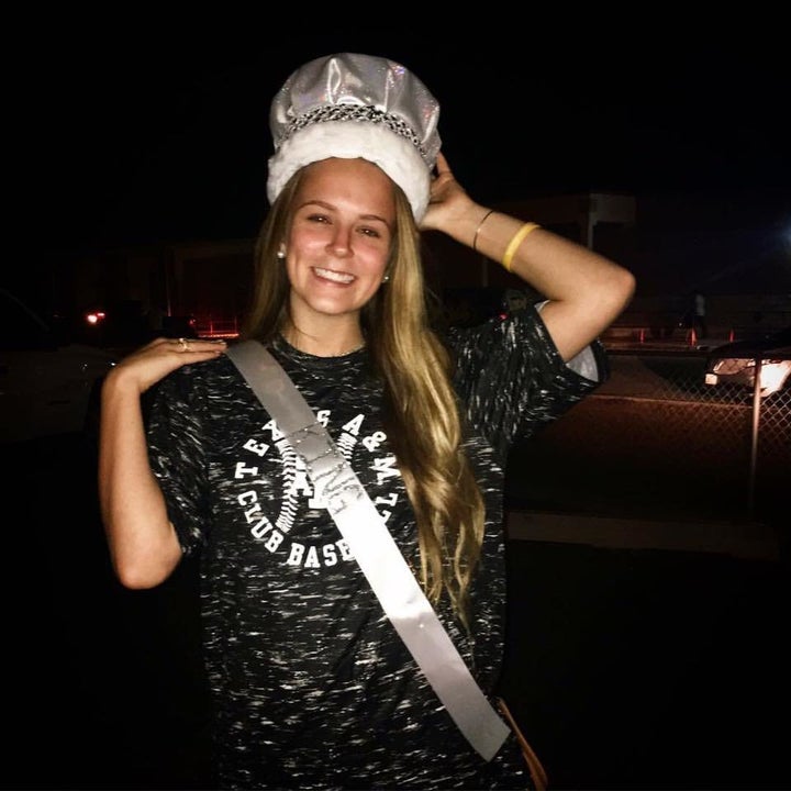 Nick's sister Ashley posing with his crown and sash.