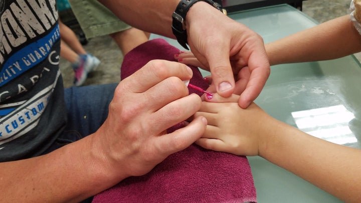 Morgese painting daughter Emma's nails. 