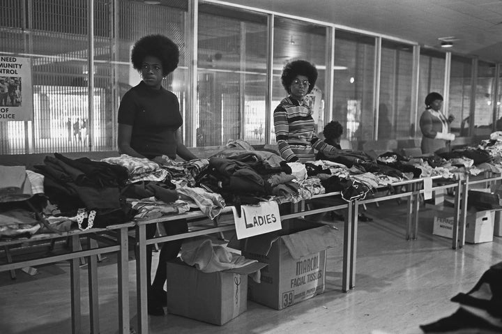 Members of the Black Panther Party stand behind tables ready to distribute free clothing to the public in New Haven, Connecticut.